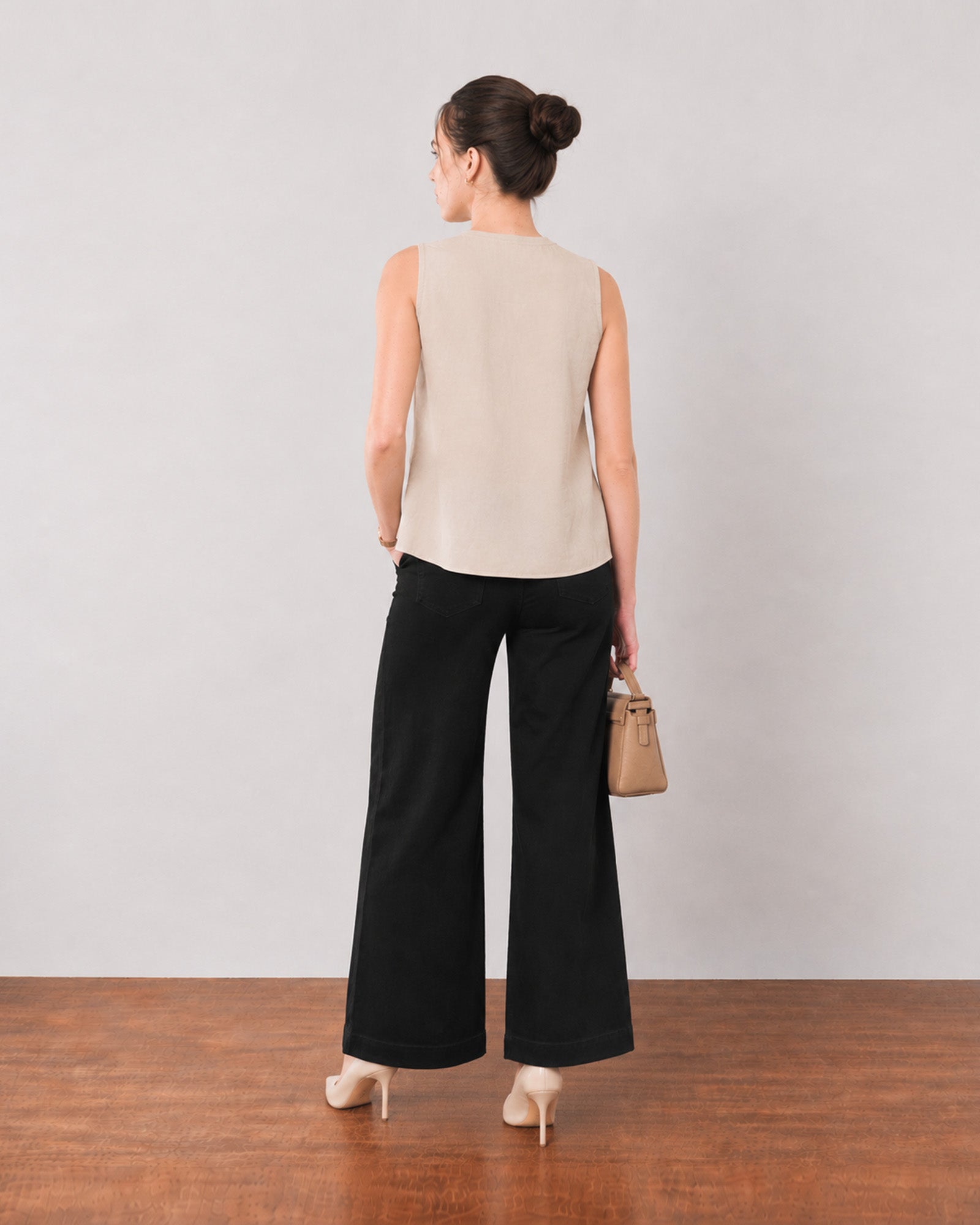 Gill beige linen top, back view showing the relaxed fit and broad flared hemline