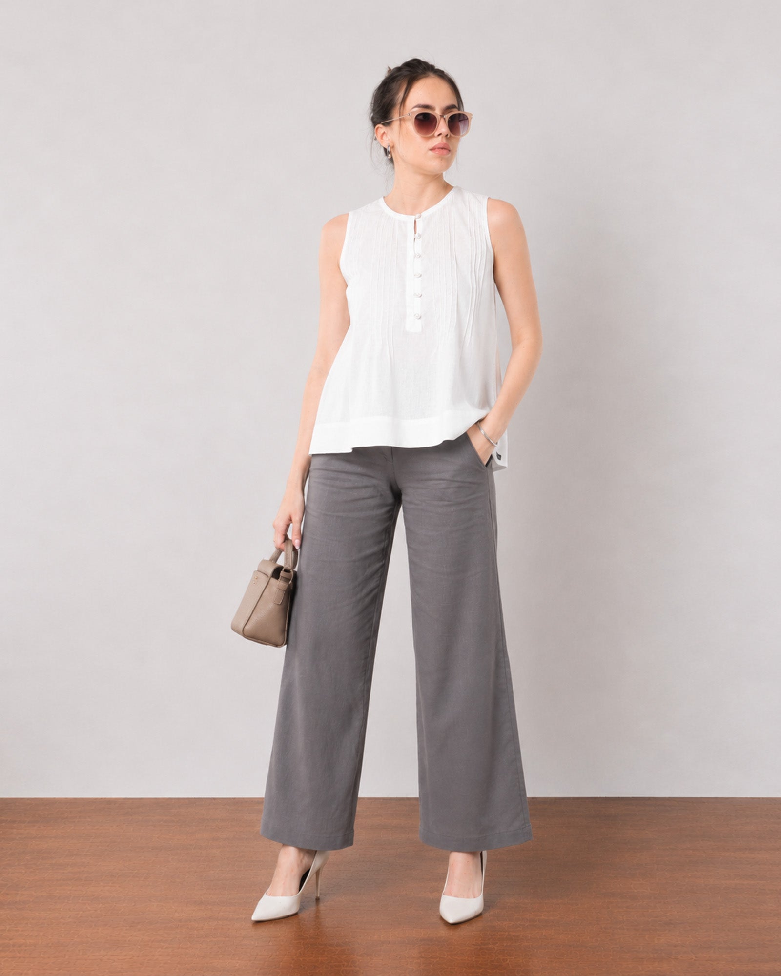 Gill white sleeveless linen top with delicate pin tucks, angled front view