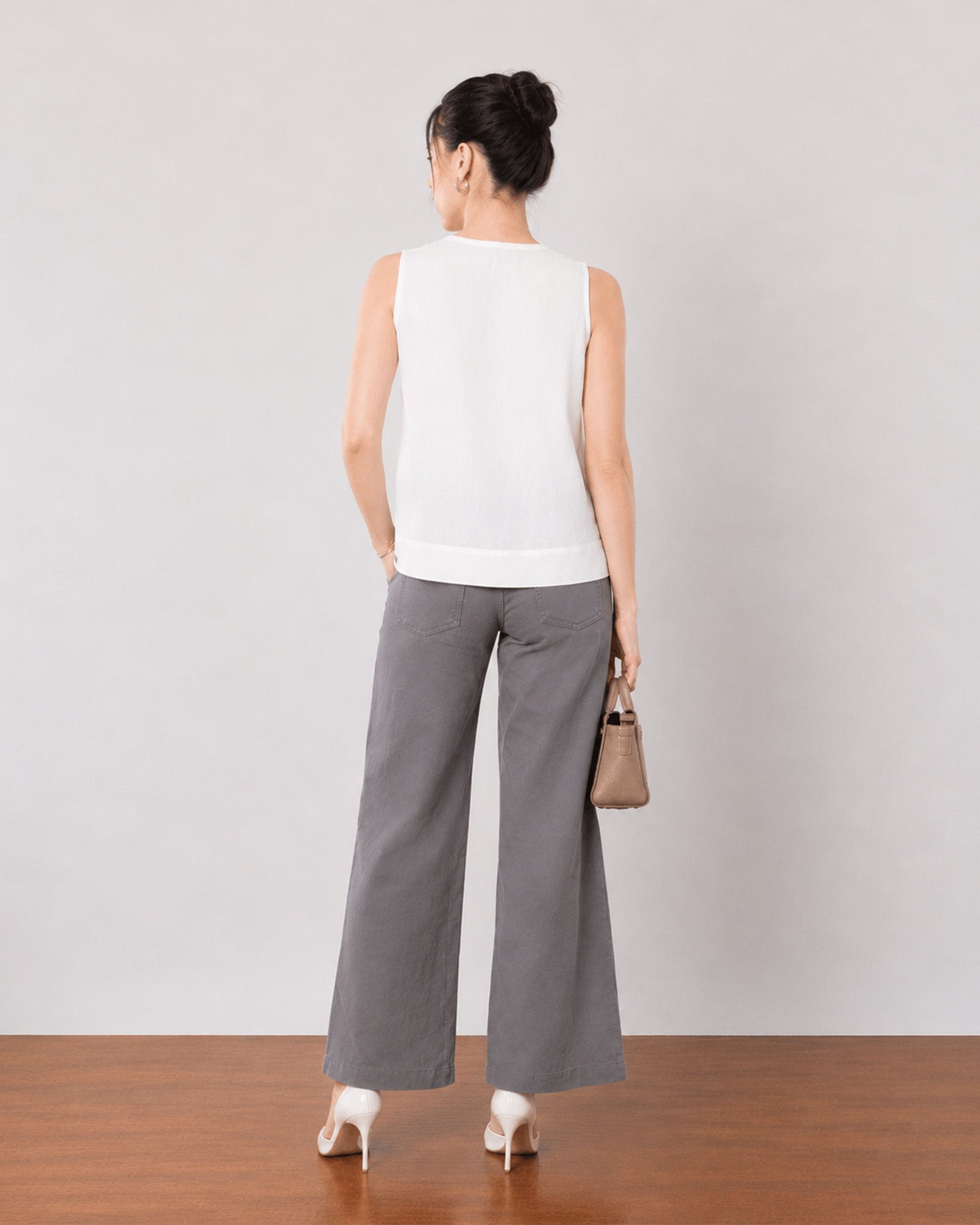 Gill white linen top, back view showing the relaxed fit and broad flared hemline