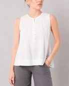 Gill white pin tuck top with a wide banded hemline and relaxed drape, front detail
