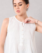 Close-up of Gill white linen top Henley neckline, button placket and fine pin tuck pleats