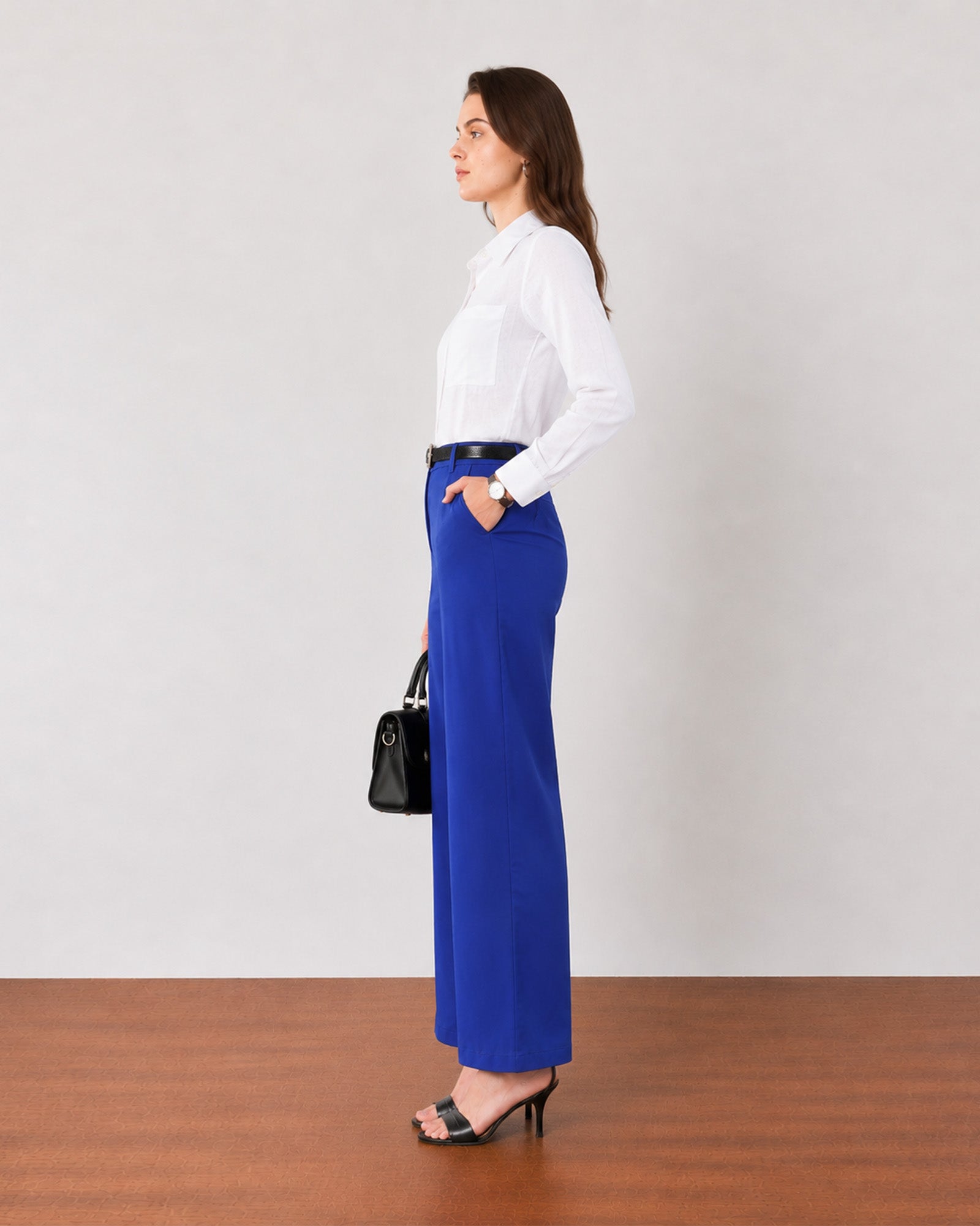 Glin royal blue cotton satin pants with structured front pleats, side profile showing the broad leg drape