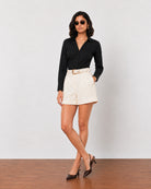 Goldy beige high waisted linen shorts with functional side pockets, walking view