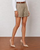 Close-up of Goldy muddy brown linen shorts high waistband, tan belt and double front pleats