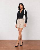 Grace beige lyocell linen shorts with a cuffed hem, angled three-quarter front view