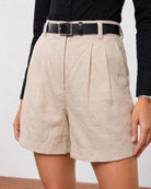 Close-up of Grace beige linen shorts high waistband, belt loops and double front pleats
