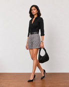 Grace charcoal grey high waisted pleated shorts, walking view