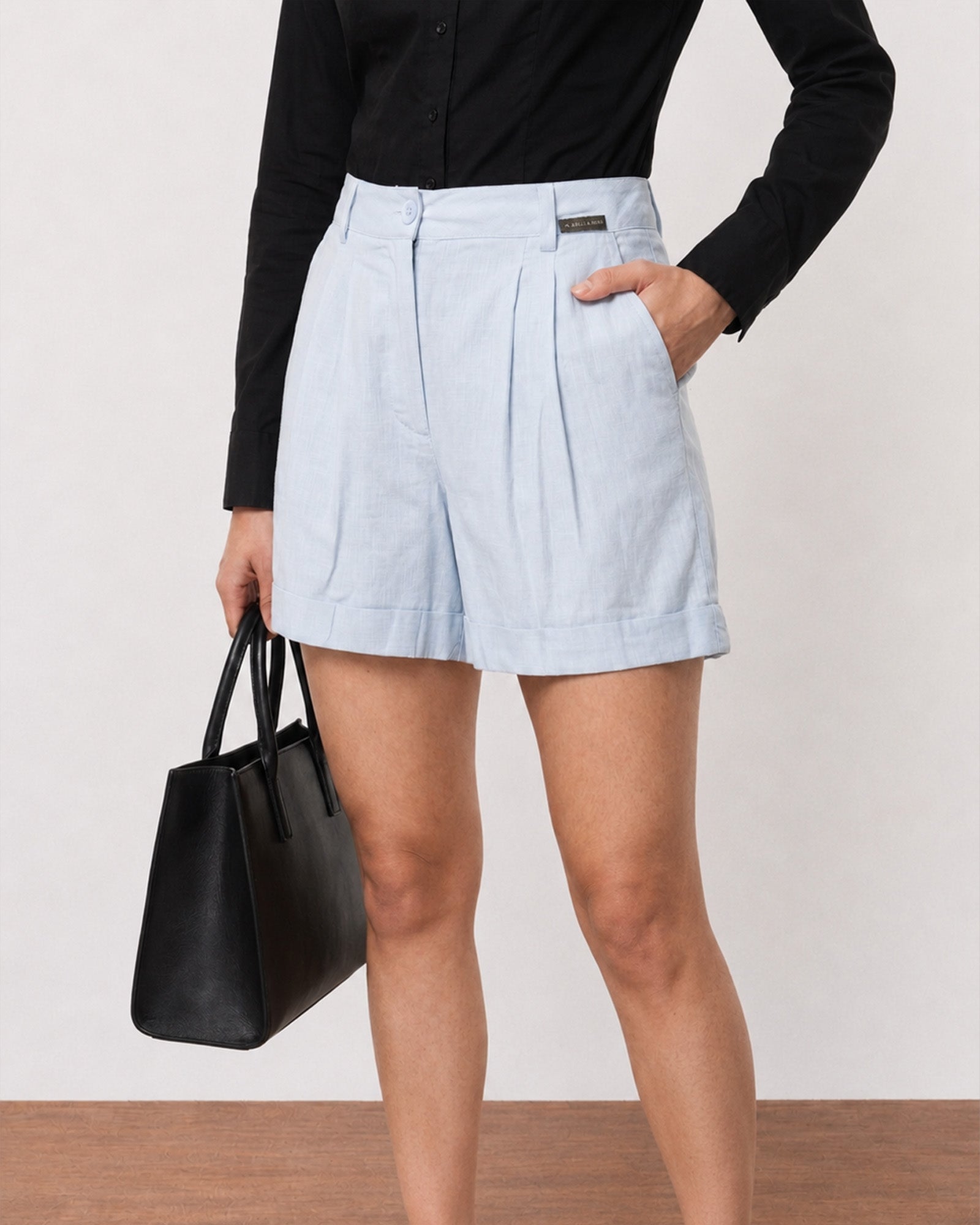 Close-up of Grace sky blue linen shorts high waistband, belt loops and slim belt