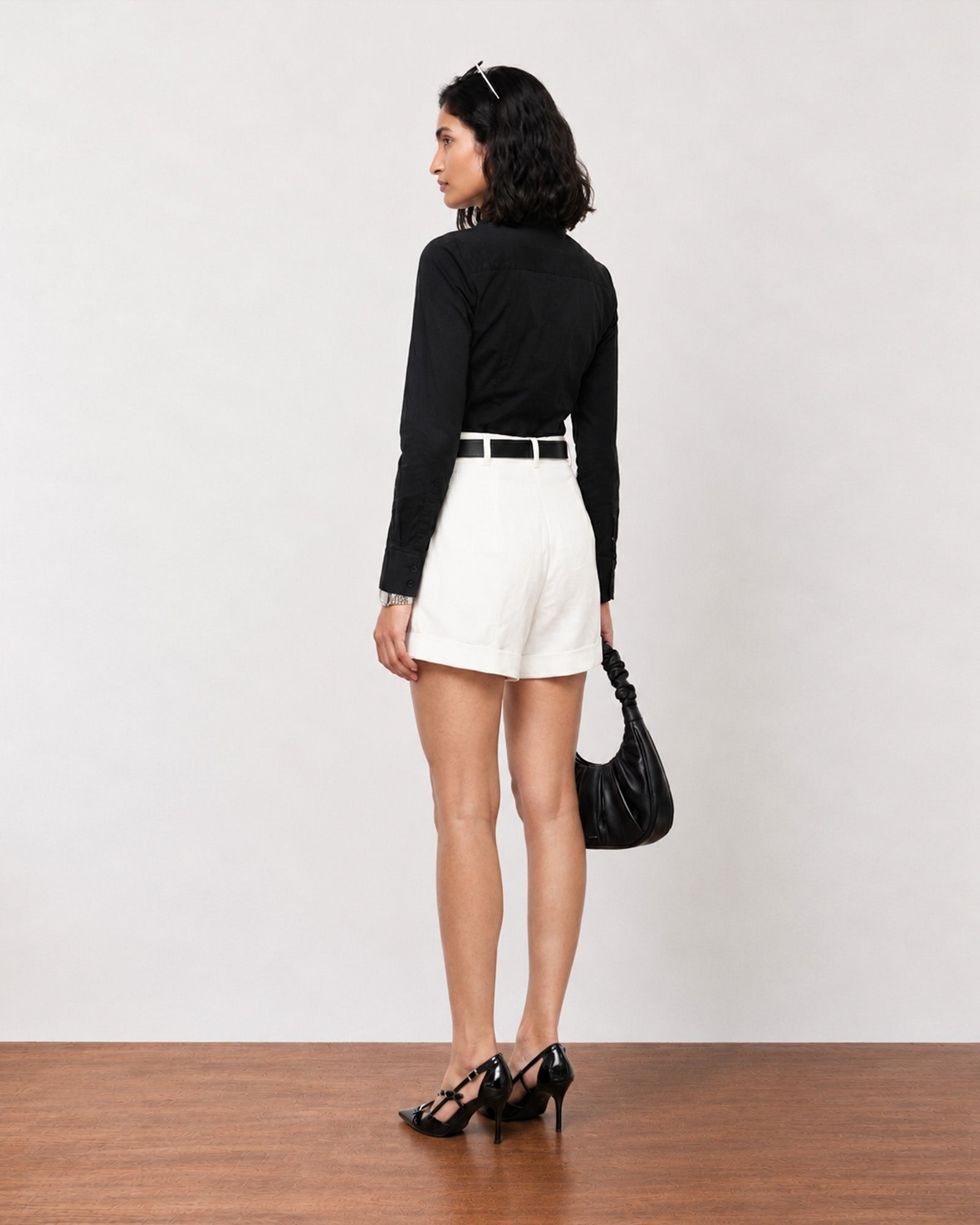 Grace white high waisted linen shorts, back three-quarter view showing the pleated fall