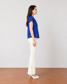 Greta royal blue office top with folded cuff sleeves, side profile view