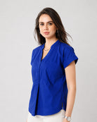 Greta royal blue cotton satin top with neat folded cuff sleeves, close-up view