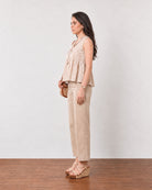 Gretchen beige cotton linen peplum top with a floating hem, back three-quarter view