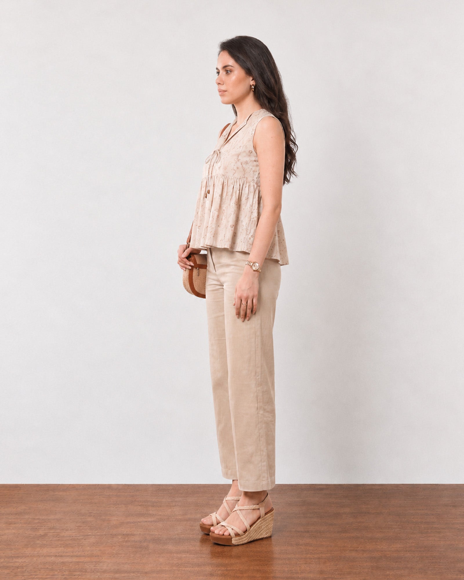 Gretchen beige cotton linen peplum top with a floating hem, back three-quarter view
