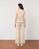 Gretchen beige printed peplum top with a gathered peplum seam, back view