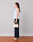 Gusta sky blue pin tucks top with a sleeveless armhole, side profile view