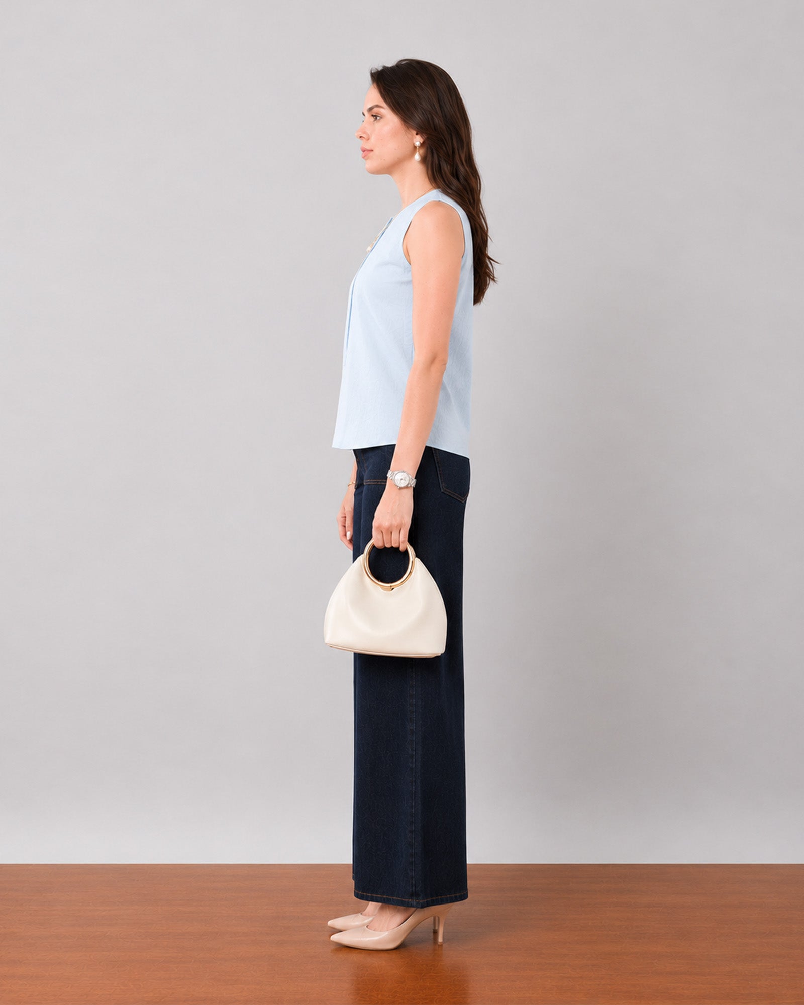 Gusta sky blue pin tucks top with a sleeveless armhole, side profile view