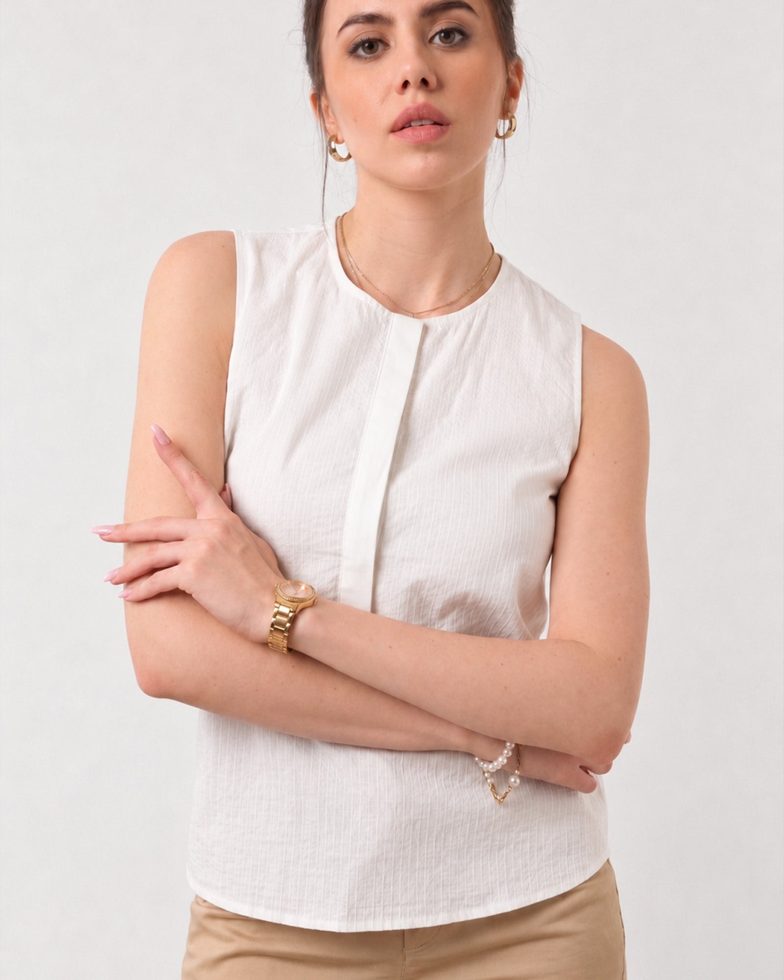 Close-up of Gusta white top round neckline and front button placket