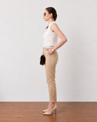 Gusta white pin tucks top with a sleeveless armhole, side profile view