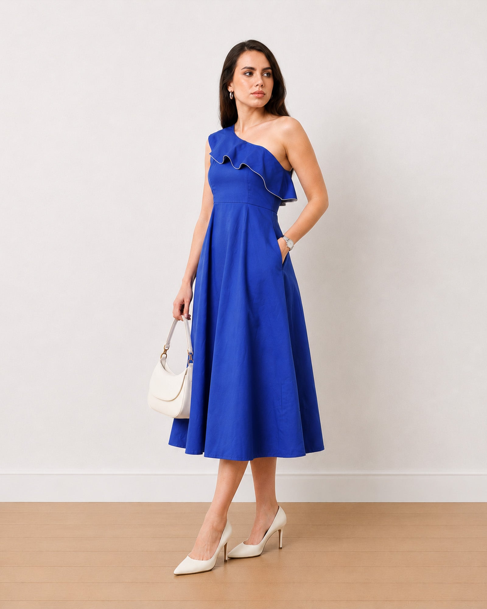 Gweneth royal blue one shoulder dress with functional side pockets, angled three-quarter view