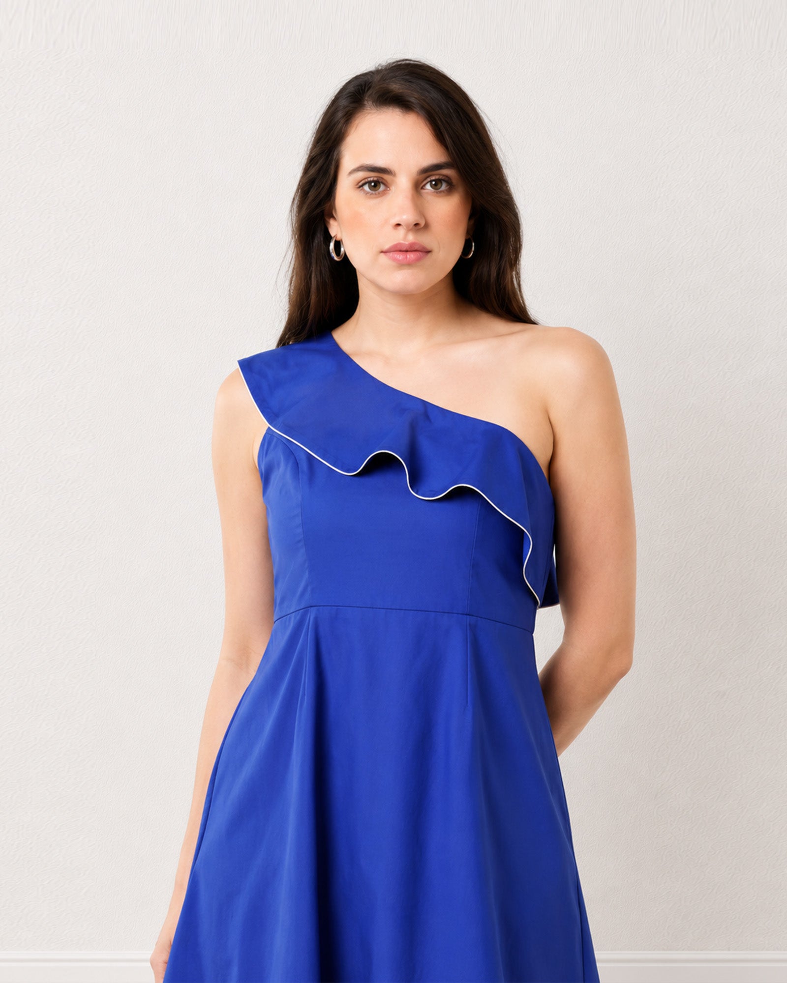 Gweneth royal blue cotton midi dress with a ruffle neckline and empire waist seam, close-up view