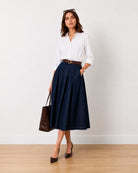 Hansel indigo blue denim pleated midi skirt, front view with belt loops and side pockets