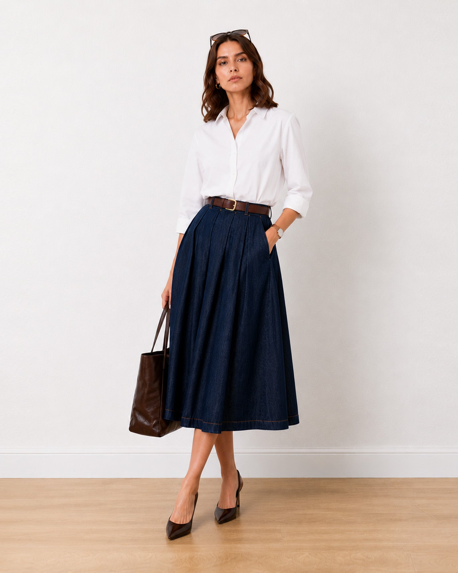 Hansel indigo blue denim pleated midi skirt, front view with belt loops and side pockets