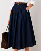 Close-up of Hansel indigo blue denim skirt front pleats and side pocket in 100% cotton