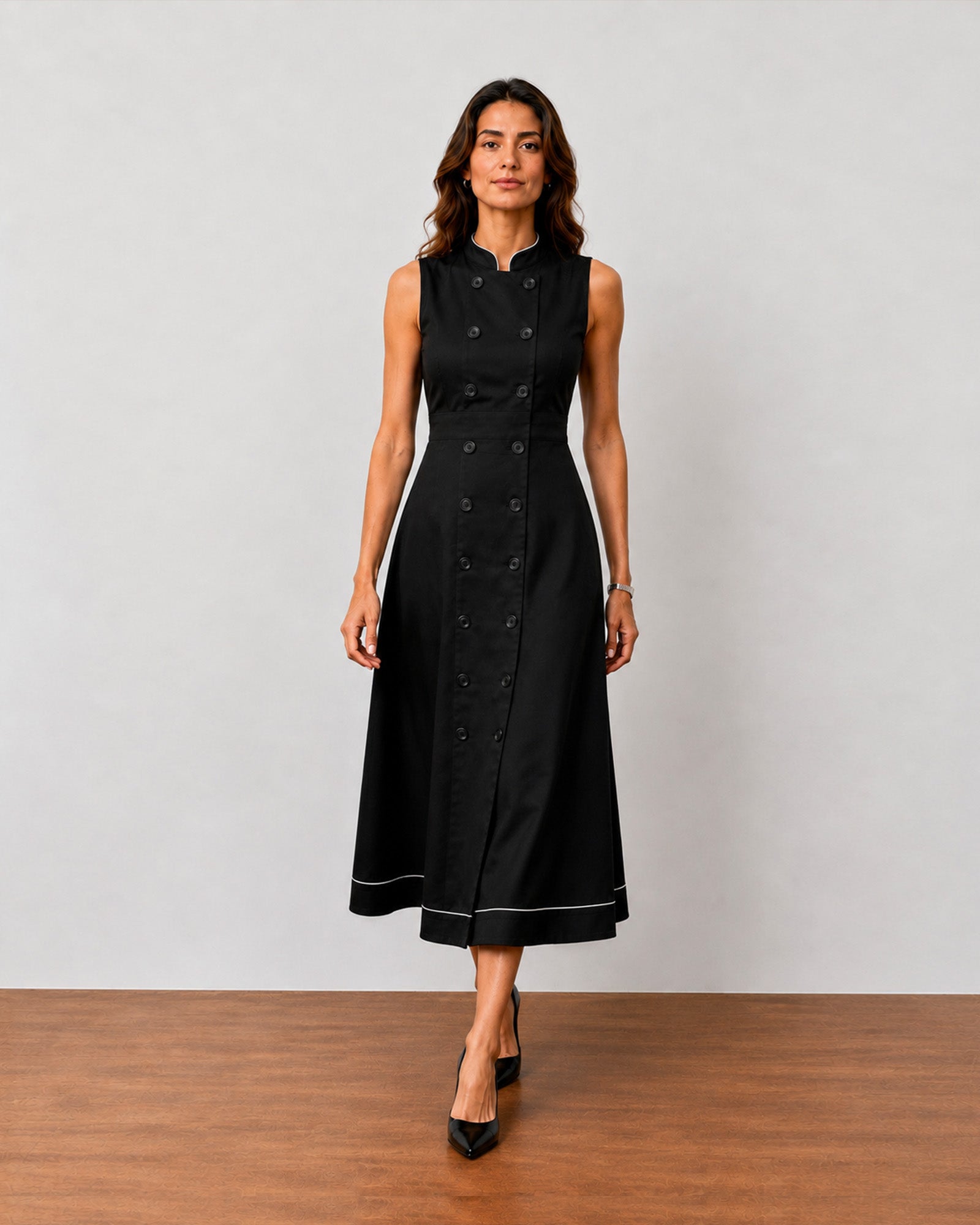 Hectoria black double breasted cotton dress with cotton voile lining and side pockets, angled front view