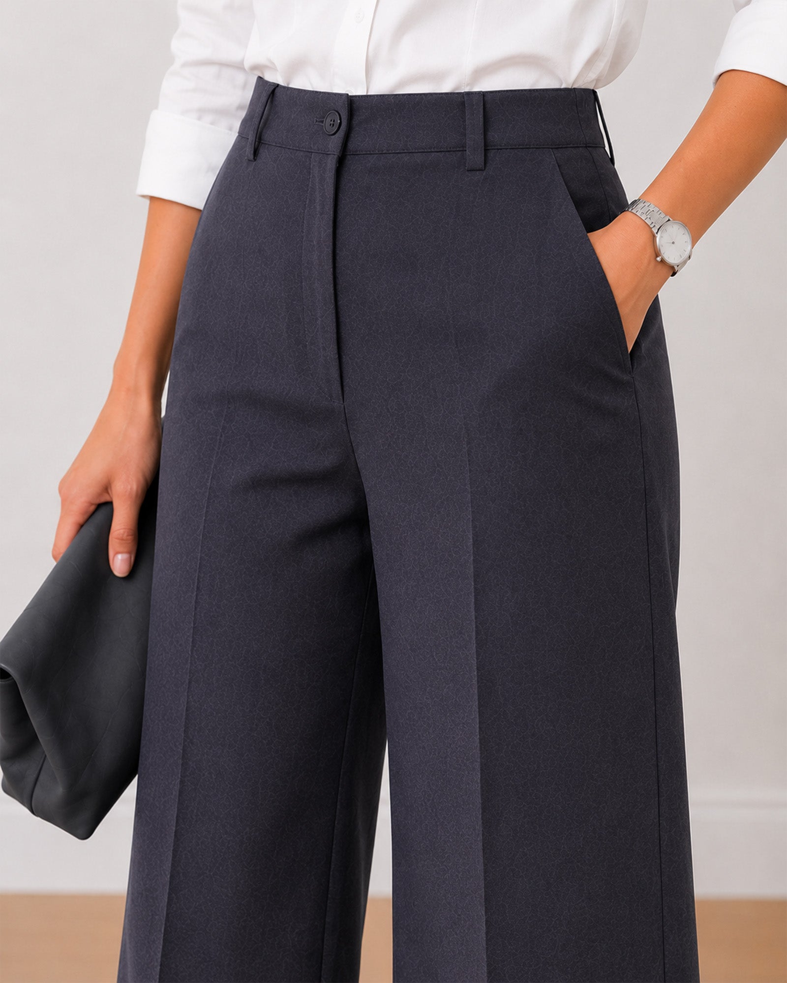 Close-up of Henrietta dark grey pants showing cotton herringbone texture and fly front