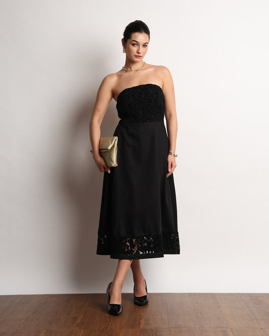 Here black strapless midi dress with a lace bodice and scalloped lace hem band, front view