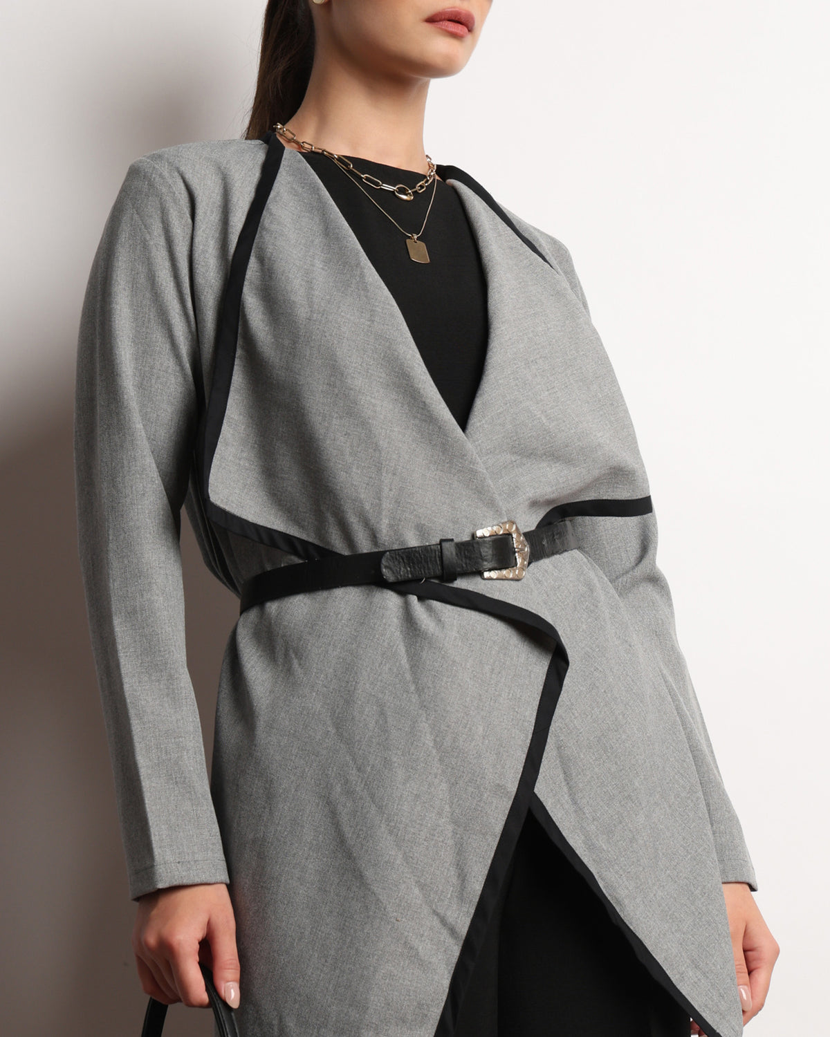 Close-up of the Hermina dark grey cape top showing the neckline and drape