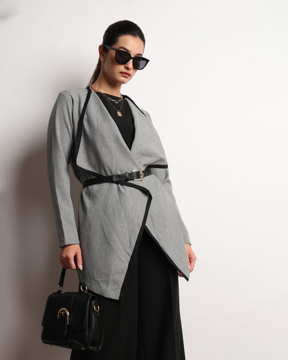 Hermina dark grey drapy cape top worn belted and styled with a shoulder bag, front view