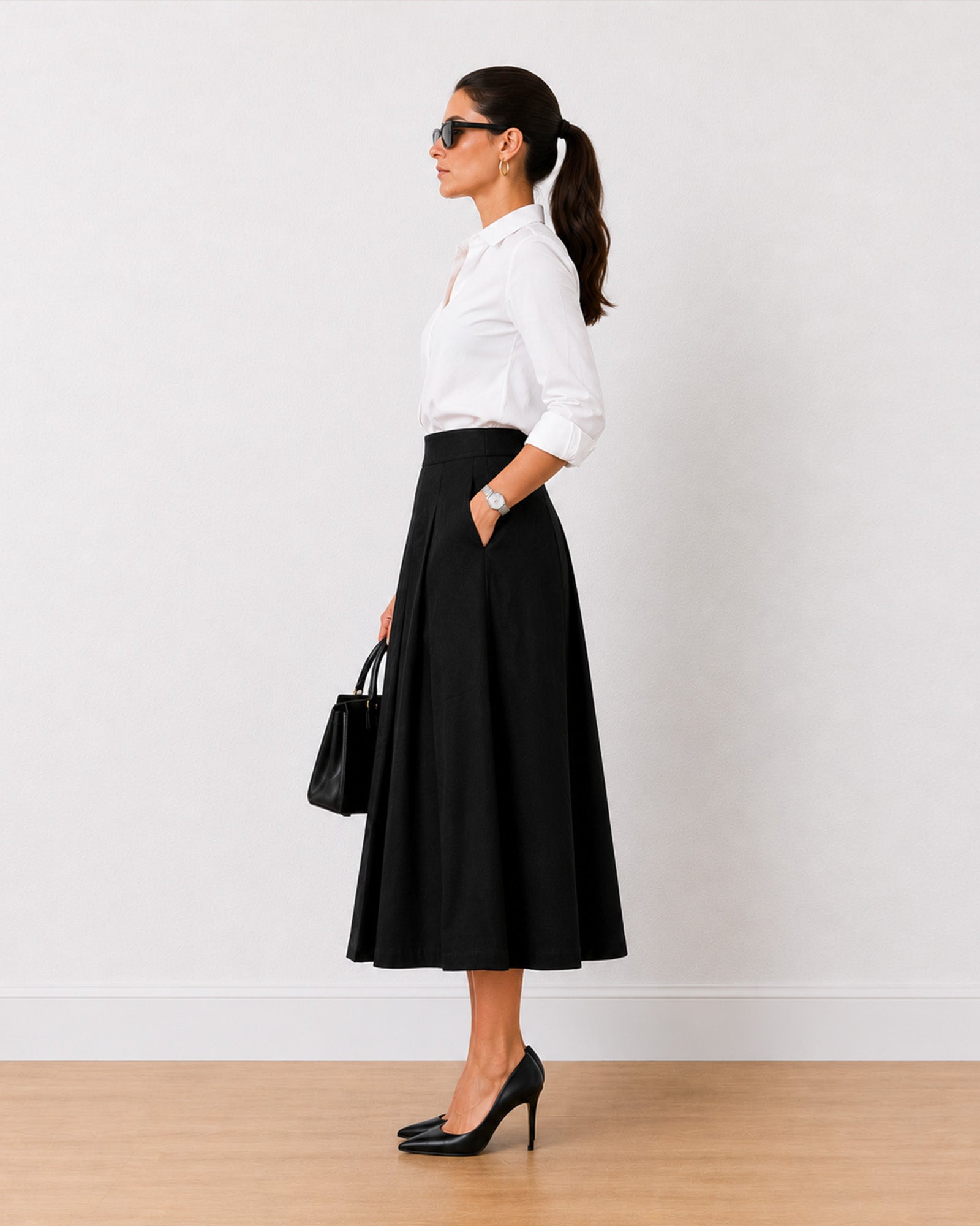 Hester black full midi skirt, side profile showing high-rise waist and front pleats