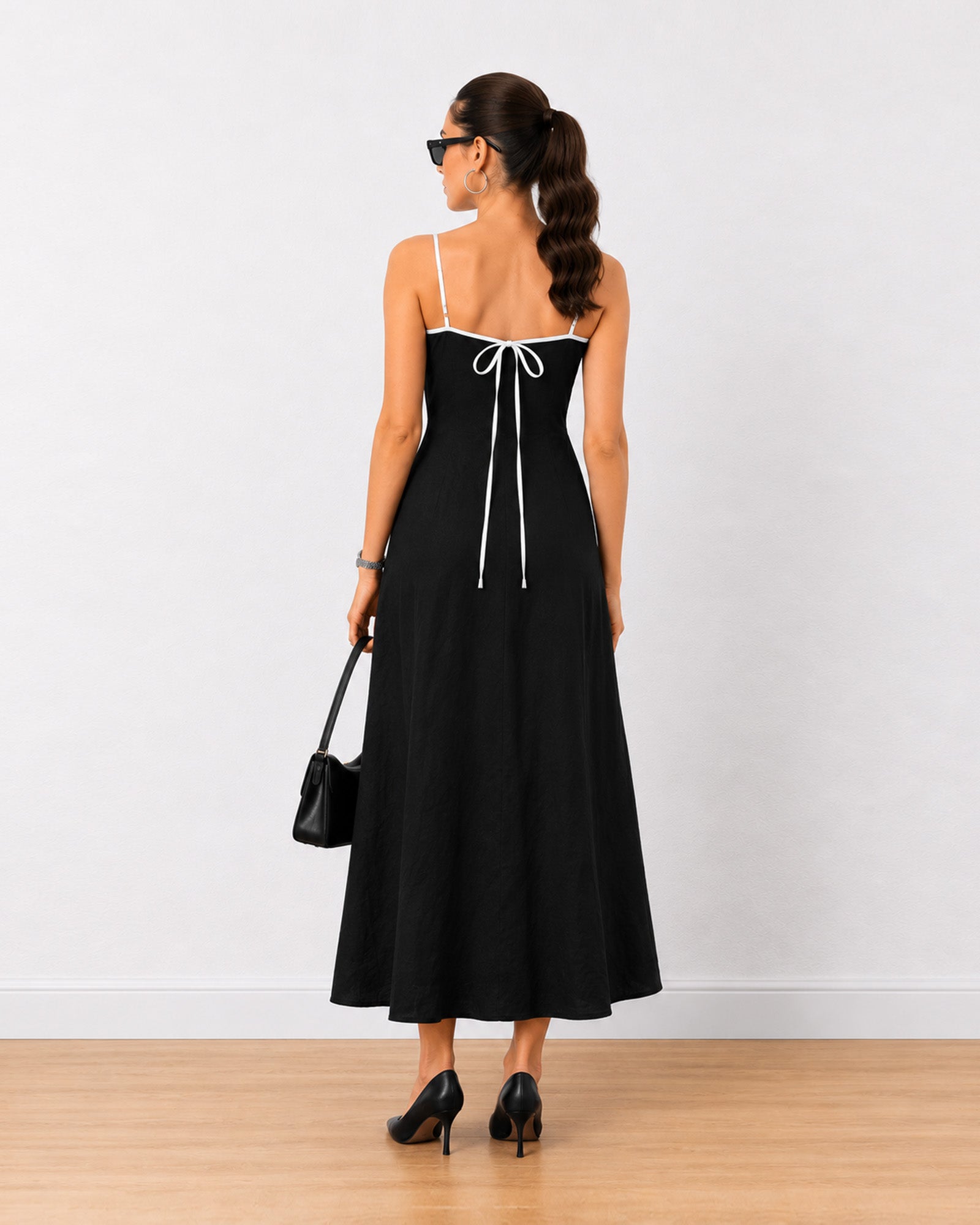 Holiday black linen maxi dress, back view showing tie detail and flowy A-line fall