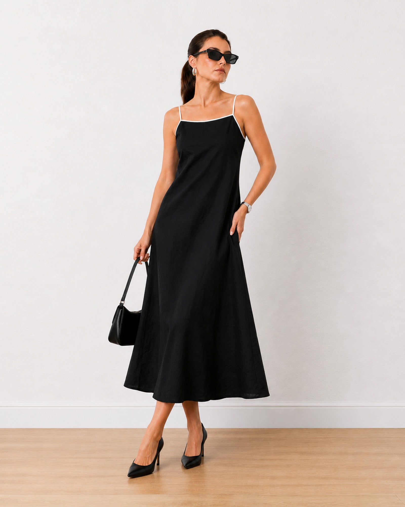 Holiday black linen maxi dress styled with heels for holiday and resort wear
